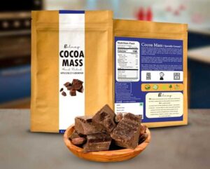 vegan cocoa mass from bolmay cocoa packaging with a plate of raw cocoa mass blocks in front of package